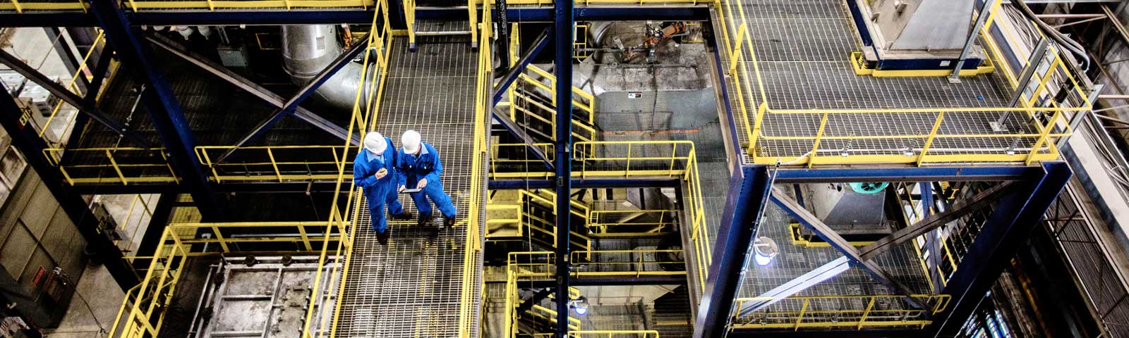 Two manufacturing workers overseeing a factory