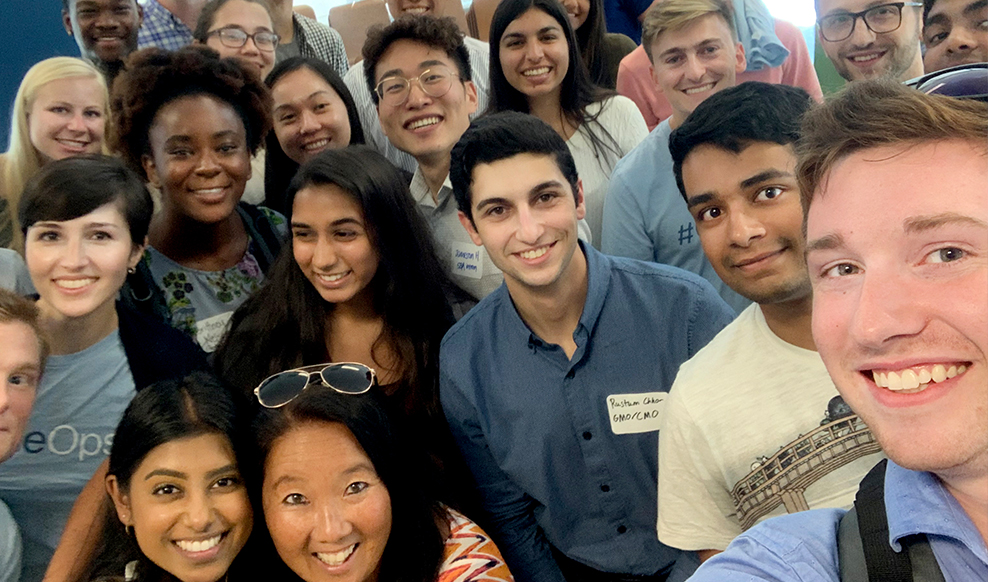 Selfie of large group of people smiling.